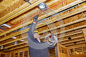 Installing electric wiring lights and ceiling in new home new home construction