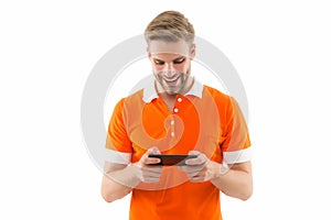 Installing game. Exciting gaming. Mobile repair. Happy handsome man hold cell phone. 5G fast connection. Mobile