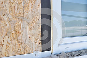 Installing house PVC window with waterproofing membrane and insulation for house energy saving