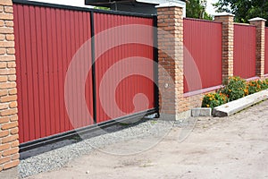 Installing house red metal fence with garage gate of modern style design
