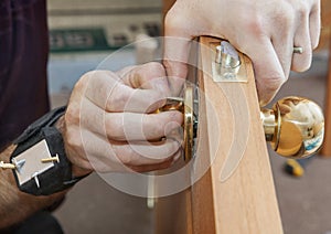 Installing interior door, carpenter installs knob using magnetic