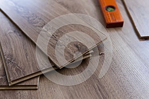 Installing laminated floor, detail on wooden tiles ready to be fit.