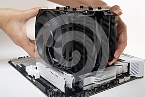 Installing a large cooler on a computer processor.