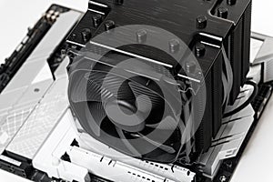 Installing a large cooler on a computer processor.