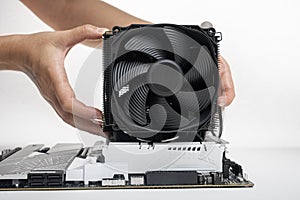 Installing a large cooler on a computer processor.