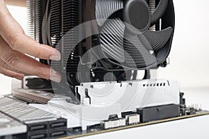 Installing a large cooler on a computer processor.