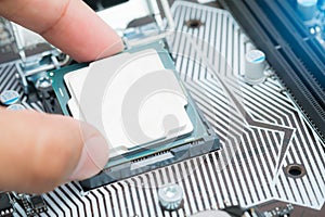 The engineer Installing CPU in socket computer motherboard