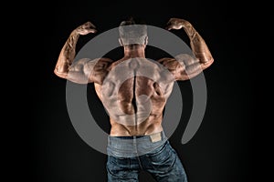 Installing muscles. Sportsman flex arms back view. Sportsman show biceps triceps. Strong sportsman or bodybuilder black