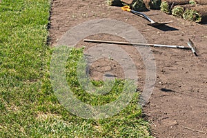 Installing new grass turfs from a roll - Garden building theme