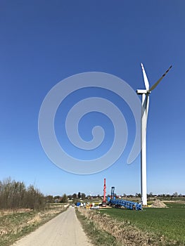 Installing a new windmill or wind turbine in a field. Power industry