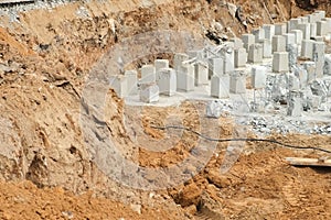 Installing piles, work in laying the foundation building on construction site.