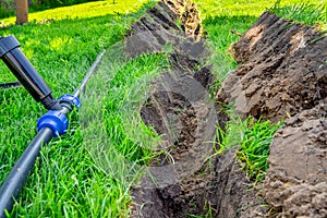 Installing a pop-up sprinkler in the lawn, close-up. Grass Irrigation Integration