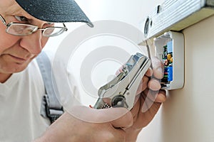 Installing a programmable room thermostat.