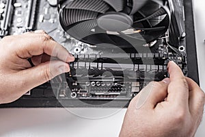 Installing random access memory into PC.