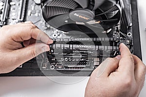 Installing random access memory into PC.