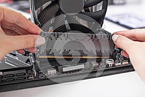 Installing random access memory into PC.