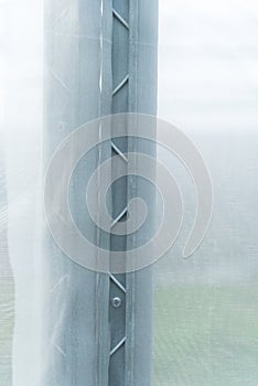 installing screw the Channel Wire Lock to greenhouse photo