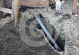 Installing sewer pipe in the ground trench