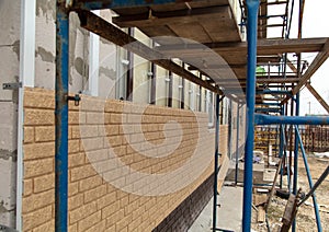 Installing siding on the walls of the house