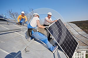 Installing solar photovoltaic panel system on roof of house photo