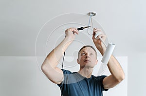 Installing a spotlight in the room.