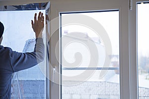 Installing window film in the office. Protection from ultraviolet radiation. Protective film