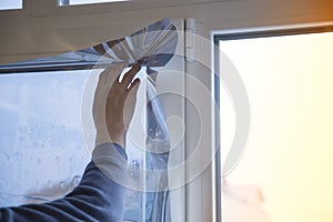 Installing window film in the office. Protection from ultraviolet radiation. Protective film