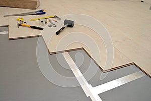 Installing wood board during flooring work