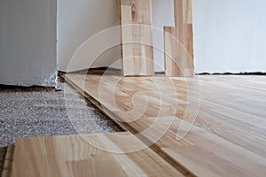 Installing wood parquet board during flooring work