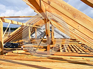 Installing wooden beams, logs, timber, rafters, trusses for house attic construction. Roofing construction.