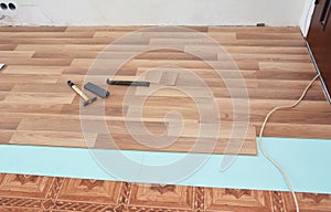 Installing wooden laminate flooring.