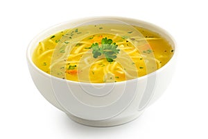 Instant chicken noodle soup in a white ceramic bowl isolated on white. Parsley garnish photo