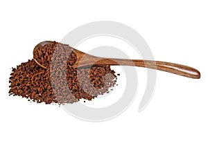 Instant coffee grains in wooden spoon on white background