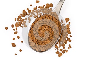 Instant coffee granules in spoon, close-up in selective focus