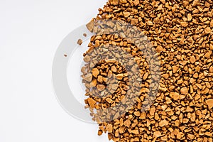 Instant coffee granules on a white acrylic background