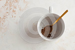 Instant coffee is poured into a white mug. July 24, instant coffee`s birthday. Copy space