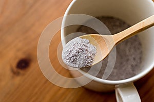 Instant coffee powder 3 in 1; mixed with milk powder and sugar in a cup.