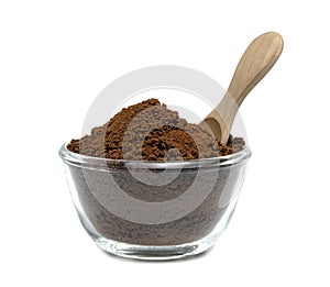 Instant coffee powder with glass bowl and wooden spoon isolated on white background