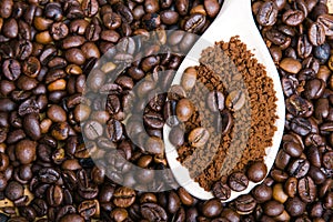 Instant coffee in spoon on coffee beans