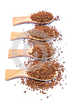 Instant coffee in wooden spoon on white background