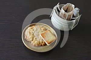 Instant freshly brewed cup of coffee,Drip bag fresh coffee served with cream crackers .  copy space for text insertion