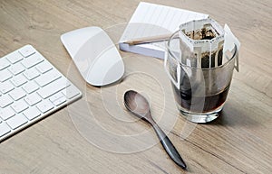 Instant freshly brewed cup of coffee or paper dripping bag on a