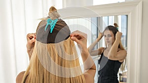 Instant hair extensions on hairpins for volume and elongation. blonde strands