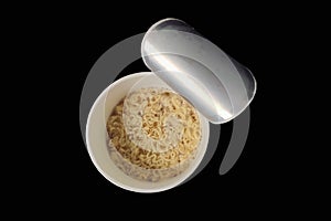 instant noodle cup on black background