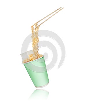 Instant noodles on wooden chopstick from a cardboard cup on a white background
