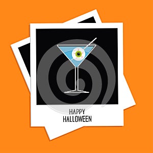 Instant photo with martini glass blue cocktail and eyeball. Halloween card. Flat design.