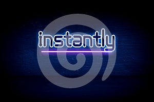 Instantly - blue neon announcement signboard photo