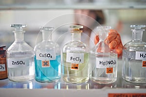 An institution employee handling bottles with chemicals in the laboratory. Chemistry, chemicals, lab