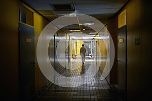 An institution employee walking a hallway. Institution, hallway, university photo