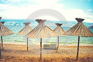 Instragram retro effect on photo, beach umbrellas with straws